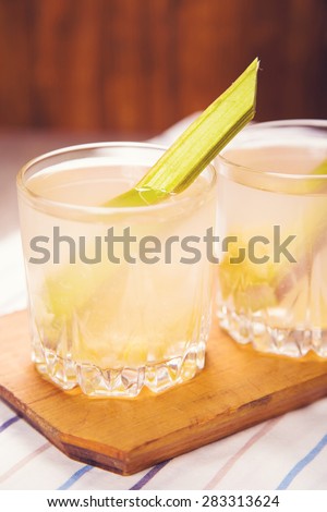 fresh fruit compote from pieplant in glasses on wooden background