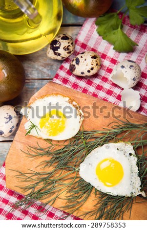 fried eggs on frying pan with bread,oil in studio
