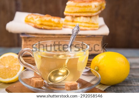 fresh lemon pie with tea,lemon fruits on old book