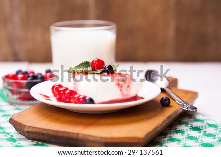 fresh curd with cherry, currant and sweet sauce on white plate