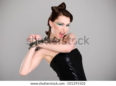 young beautiful woman with chain and makeup studio shot