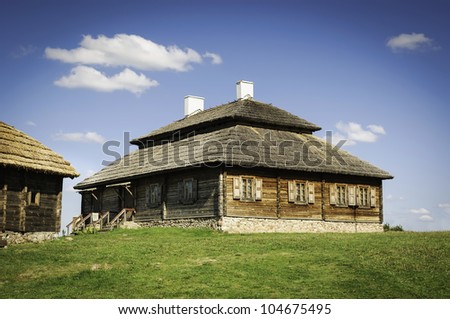 Beautiful landscape with restored old style russian farmhouse with thatch roof