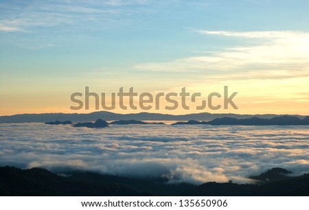 Sun rise over valley of fog in Thailand