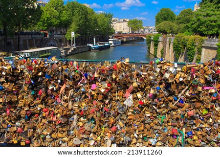 PARIS, FRANCE - May 3, 2014: locks on the railing of the bridge over the Seine, the lovers as a sign of loyalty to leave the locks on the railing of the bridge