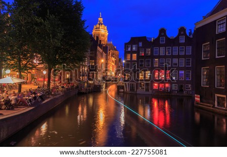 Amsterdam, Netherlands - August 3, 2014: View of the embankment and canal of Amsterdam at night.
