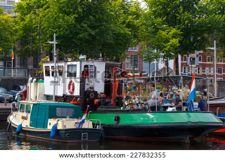 Amsterdam, Netherlands - July 31, 2014: Traditional house boat on the canals of Amsterdam. In Amsterdam, there are about 2,500 homes on the water.