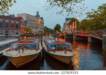 Amsterdam, Netherlands - July 31, 2014: View of the embankment and canal of Amsterdam at night.