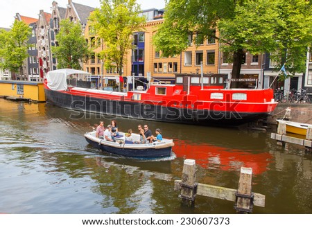 Amsterdam, Netherlands - July 29, 2014: Canals of Amsterdam. Favorite place for walking and leisure travelers.