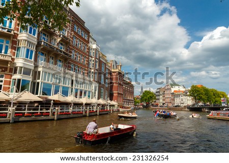 Amsterdam, Netherlands - August 3, 2014: Canals of Amsterdam. Favorite place for walking and leisure travelers.