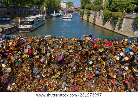 PARIS, FRANCE - May 3, 2014: locks on the railing of the bridge over the Seine, the lovers as a sign of loyalty to leave the locks on the railing of the bridge
