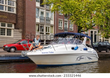 AMSTERDAM,THE NETHERLANDS - July 29, 2014: Canals of Amsterdam. Favorite place for walking and leisure travelers.