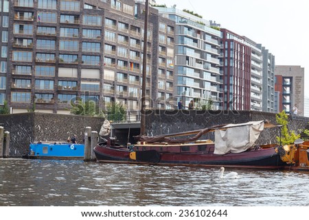 Amsterdam, Netherlands - July 29, 2014: Traditional house boat on the canals of Amsterdam. In Amsterdam, there are about 2,500 homes on the water.