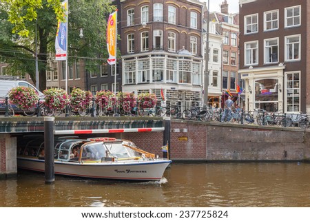Amsterdam, Netherlands - July 30, 2014: Canals of Amsterdam. Favorite place for walking and leisure travelers.
