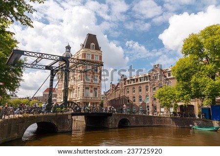 Amsterdam, Netherlands - July 30, 2014: Canals of Amsterdam. Favorite place for walking and leisure travelers.