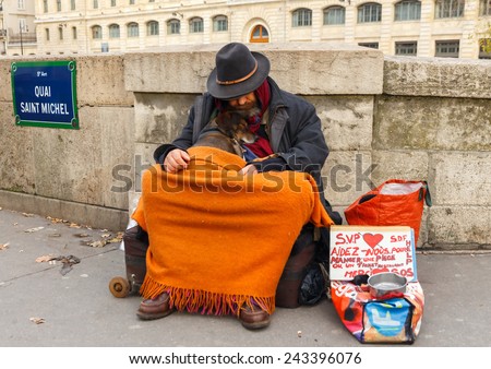 Paris, France - December 20, 2014: A homeless man with a dog on the street asking for money in Paris.