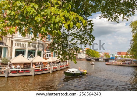 Amsterdam, Netherlands - August 3, 2014: Canals of Amsterdam. Favorite place for walking and leisure travelers.