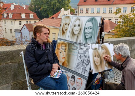 Prague, Czech Republic - October 6, 2014: The artist draws portraits on the Charles Bridge in Prague.