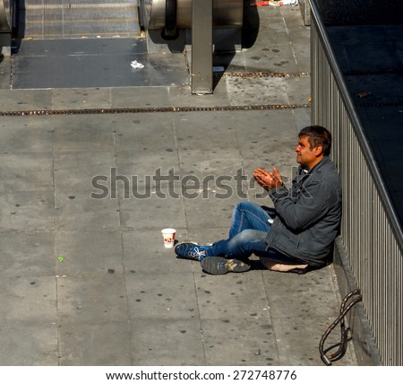 Paris, France - May 4, 2014: Paris, La Defense business district. Homeless man in the underpass