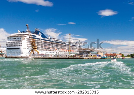 Venice, Italy - May 24, 2015: Big cruise ship docked in the port of Venice. Journey on an ocean liner is one of the most attractive and user-friendly entertainment.