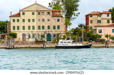 Venice, Italy - May 21, 2015: Pilot boat moored near the waterfront on an island in the Venetian lagoon. The lagoon serious shipping traffic. For large vessels required pilot.