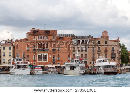 Venice, Italy - May 21, 2015: Pleasure boat tour around the main promenade of Venice. Boat trips for tourists are one of the main items of revenue to the city budget.