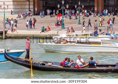 Venice, Italy - May 24, 2015: Gondolas with tourists on the Grand Canal. Gondola ride is one of the most popular tourist attractions in Venice.