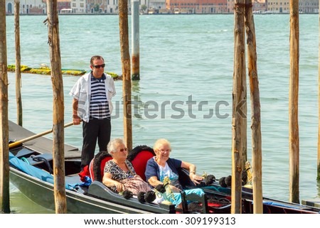 Venice, Italy - 25 May, 2015:  Two elderly women of retirement age are floating in a gondola on the Grand Canal in Venice. A gondola ride favorite amusement of tourists in Venice.