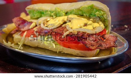 Bacon sandwich with cheese onion, tomato and avocado