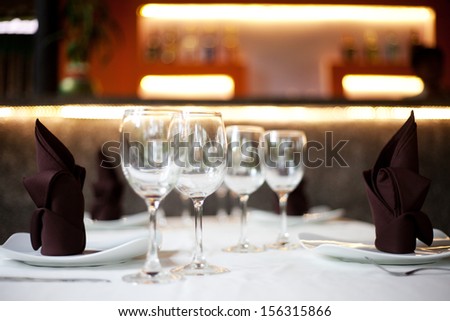 Restaurant Table With Two Menu Sets And A Bar In The Background