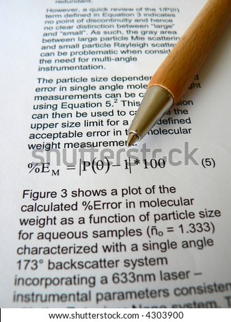 Wood pen lying on a scientific paper