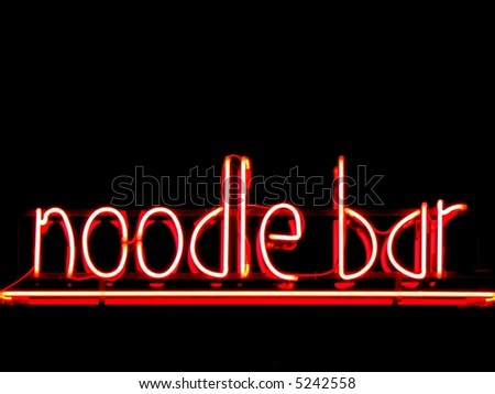 Noodle bar neon sign outside restaurant