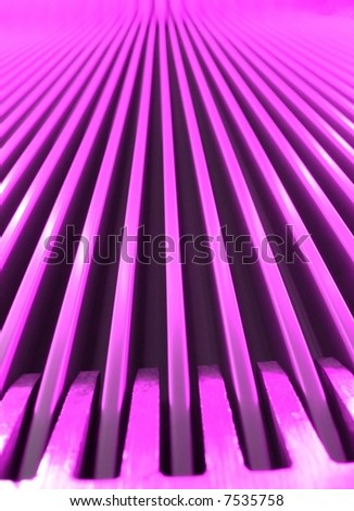 Close up ground floor view of a escalator with pink lighting