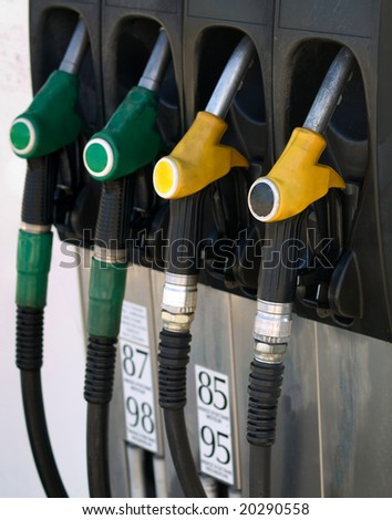 Green and yellow gas  pump rack in France no labels