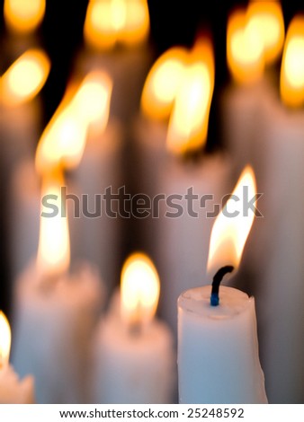 Votive candles burning in the Shrine of Lourdes