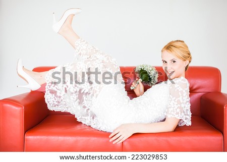 The beautiful woman. The woman in a white dress on a white sofa. isolated on white background