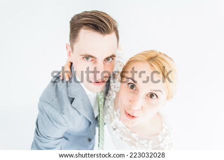 Thoughtful couple hugging and looking up - isolated over white