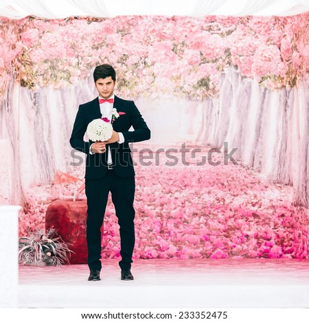 Young beautiful man with flowers