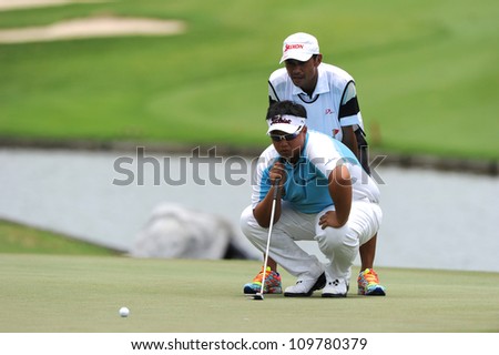 NAKHONPATHOM,THAILA ND - AUG 9:Kiradech Aphibarnrat of THA   lines up prior to putting during day one of the Golf Thailand Open at Suwan Golf&Country Club on August 9, 2012 in Nakhonpathom Thailand
