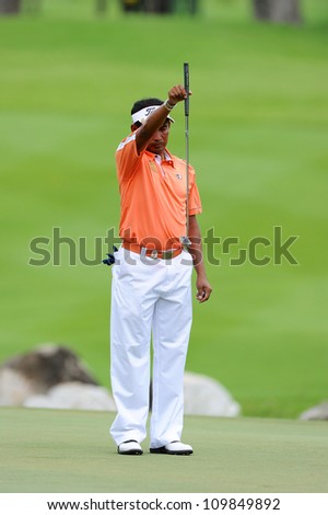 NAKHONPATHOM,THAILA ND-AUG 9:Taworn Wiratchant of THA watches lines up a shot hole 9 during day one of the Golf Thailand Open at Suwan Golf&Country Club on August 9, 2012 in Nakhonpathom Thailand