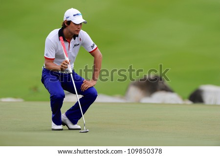 NAKHONPATHOM,THAILA ND - AUG 9:Kim Dae-hyun of KOR watches lines up a shot hole9  the first round of the 2012 Thailand Open at Suwan Golf&Country Club on August 9, 2012 in Nakhonpathom Thailand