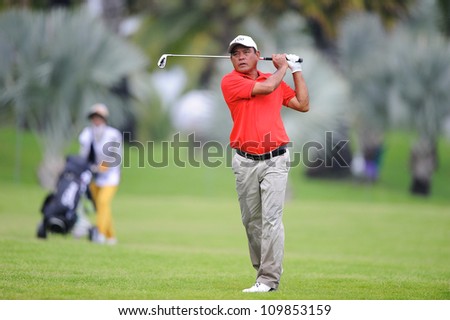 NAKHONPATHOM,THAILA ND-AUG 9:Boonchu Ruangkit of THA watches the ball after hits a shot during day one of the Golf Thailand Open at Suwan Golf&Country Club on August 9,2012 in Nakhonpathom Thailand
