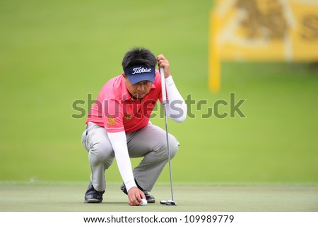 NAKHONPATHOM,THAILA ND-AUG 10:Wisut Artjanawat of THA lines up a shot during  day two of the Golf Thailand Open at Suwan Golf Club on August 10, 2012 in Nakhonpathom Thailand