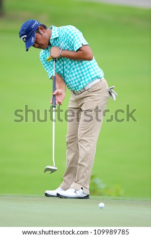 NAKHONPATHOM,THAILA ND-AUG 10:Danny Chia of MAL watches the ball after a putt shot during  day two of the Golf Thailand Open at Suwan Golf Club on August 10, 2012 in Nakhonpathom Thailand