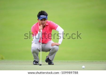 NAKHONPATHOM,THAILA ND-AUG 10:Wisut Artjanawat of THA watches the ball lines up a shot during  day two of the Golf Thailand Open at Suwan Golf Club on August 10, 2012 in Nakhonpathom Thailand
