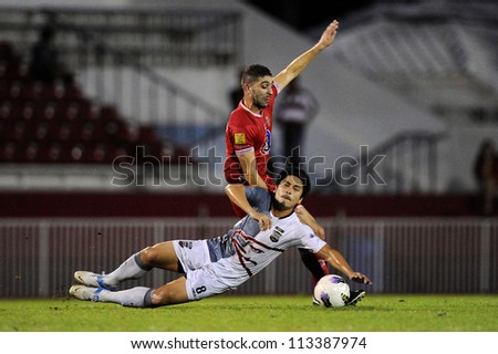 BANGKOK,THAILAND-SEPTEMBER1:Tanapat Na Tarue (white)of Insee Police Utd.in action during Thai Premier League between BEC Tero F.C.and Insee Police Utd. at Thephasadin Stadium on Sep1,2012 inThailand