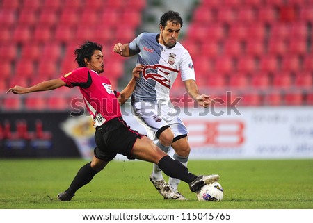 BANGKOK THAILAND-SEP15: Daniel Cortes of Insee Police Utd.(white) in action during Thai Premier League between BBCU F.C. and Insee Police Utd.at Rajamangala stadium on Sep15, 2012 in Thailand.