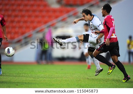 BANGKOK THAILAND-SEP15:Daniel Cortes of Insee Police Utd.(white) shot the ball during Thai Premier League between BBCU F.C.and Insee Police Utd.at Rajamangala stadium on Sep15, 2012 in Thailand.
