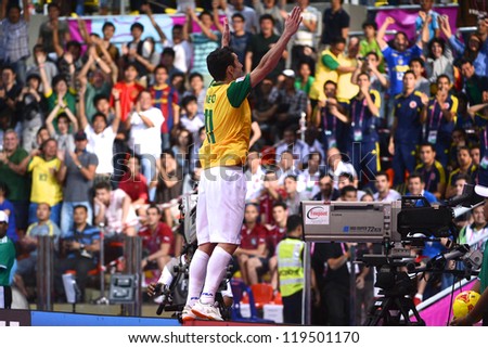 BANGKOK,THAILAND - NOVEMBER18:Neto (no.11)of Brazil celebrates with team mate  the FIFA Futsal World Cup Final between Spain and Brazil at Indoor Stadium Huamark on Nov18, 2012 in ,Thailand.