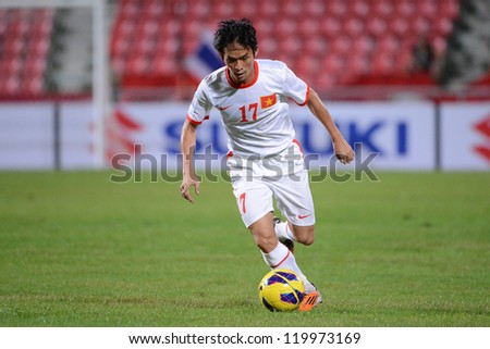 BANGKOK THAILAND-NOV 24:Nguyen Vu Phong of Vietnam (white) runs with the ball during the AFF Suzuki Cup between Vietnam and Myanmar at Rajamangala stadium on Nov24, 2012 in Bangkok,Thailand.