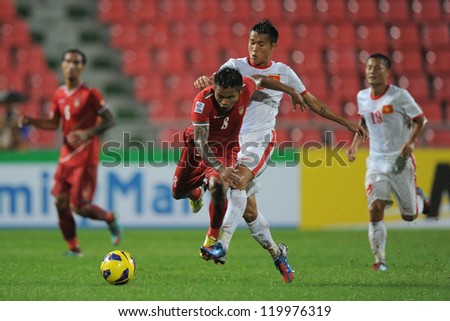 BANGKOK THAILAND-NOV 24:Kyi Lin of Myanmar (red) in action during the AFF Suzuki Cup between Vietnam and Myanmar at Rajamangala stadium on Nov24, 2012 in Bangkok,Thailand.